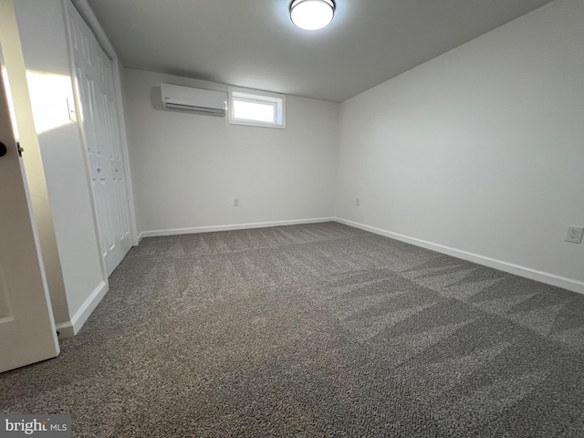 basement featuring a wall mounted air conditioner and dark carpet