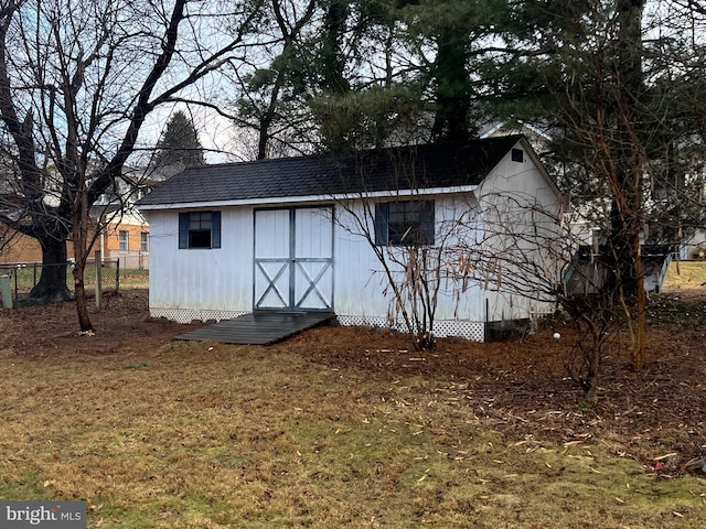 view of shed featuring fence