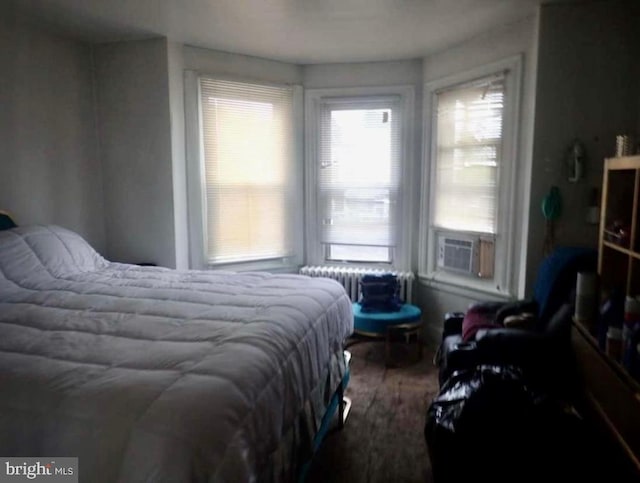 bedroom featuring radiator and cooling unit