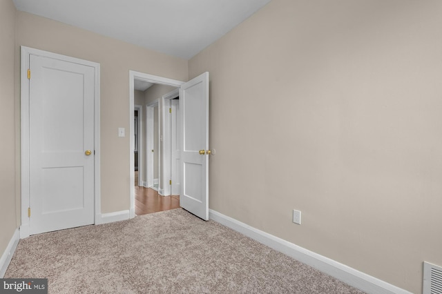 unfurnished bedroom featuring light colored carpet