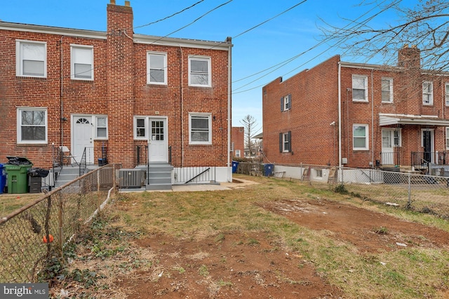 rear view of property featuring central AC