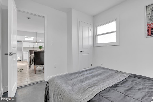 bedroom with stainless steel refrigerator