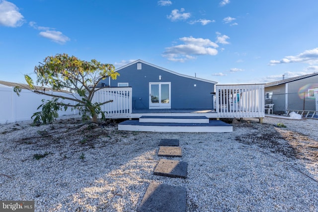 back of house featuring a wooden deck