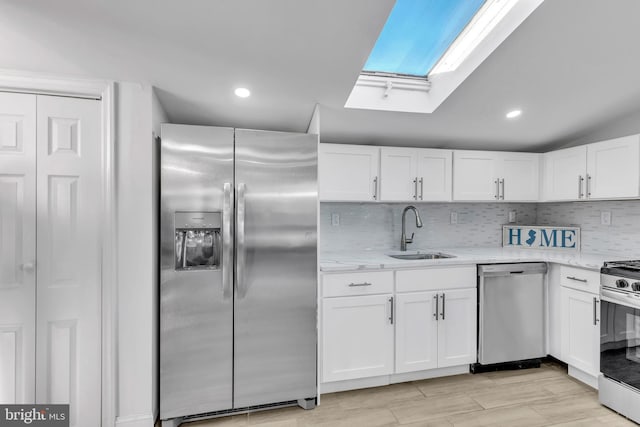 kitchen with sink, white cabinets, and appliances with stainless steel finishes