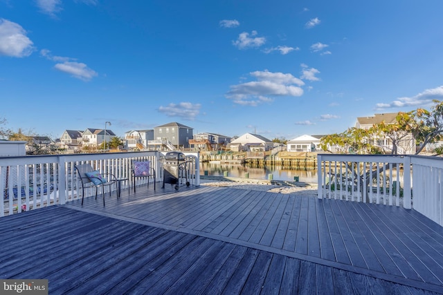 wooden deck featuring a water view