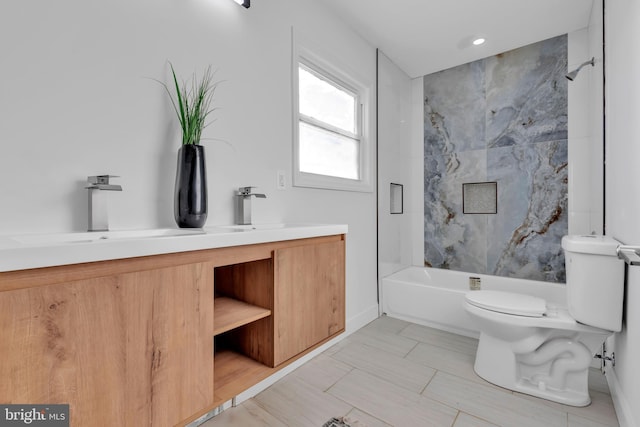 full bathroom featuring vanity, toilet, and tiled shower / bath