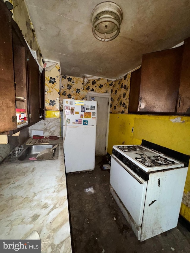 1209 Gilham St, Philadelphia, PA 19111 - kitchen featuring dark brown cabinets, sink, and white appliances