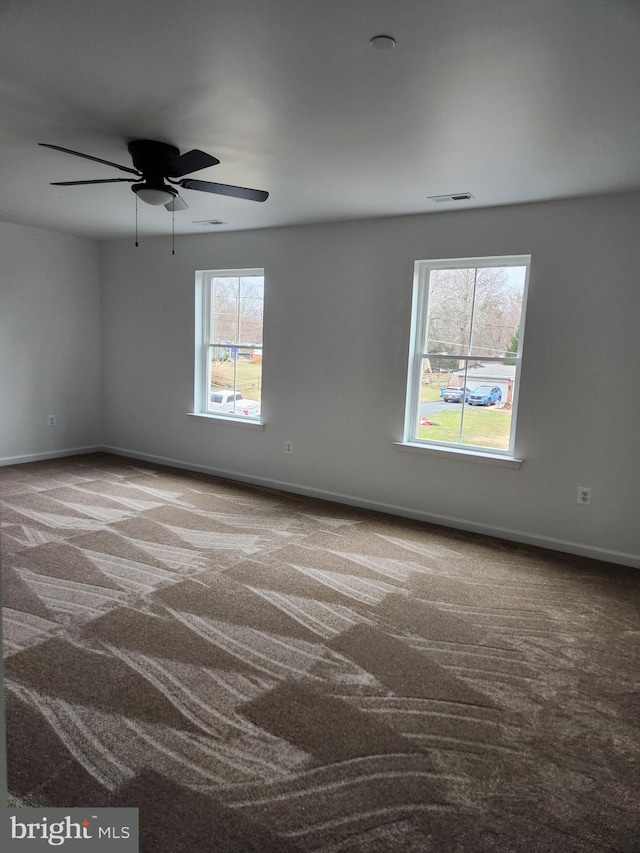 spare room with carpet floors and ceiling fan