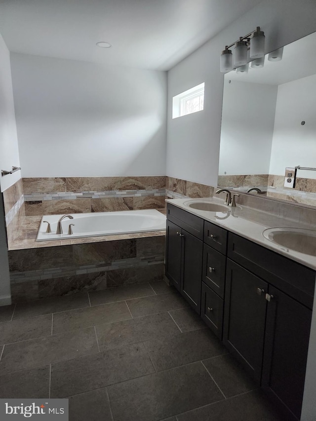 bathroom featuring a relaxing tiled tub and vanity