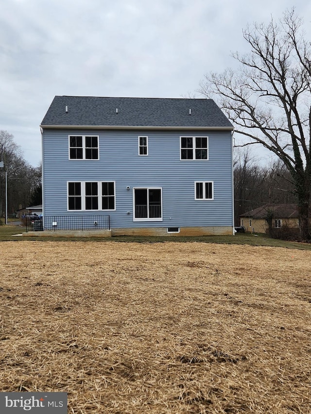 back of property with a lawn