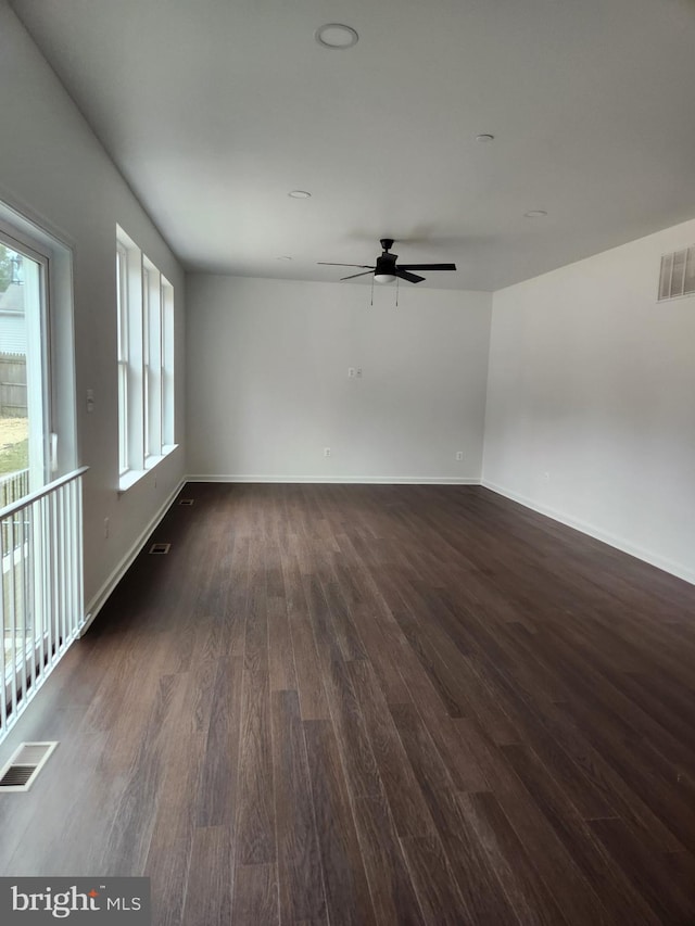 spare room featuring dark hardwood / wood-style floors and ceiling fan