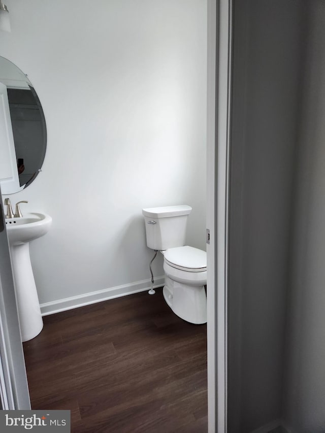 bathroom with sink, hardwood / wood-style flooring, and toilet