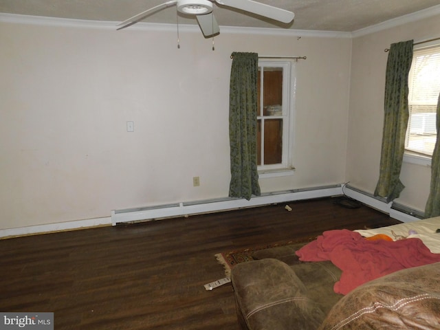 empty room with baseboard heating, dark wood finished floors, a ceiling fan, and crown molding