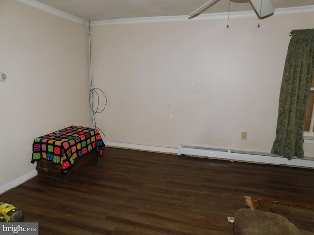 bedroom featuring a baseboard heating unit, ornamental molding, wood finished floors, and baseboards