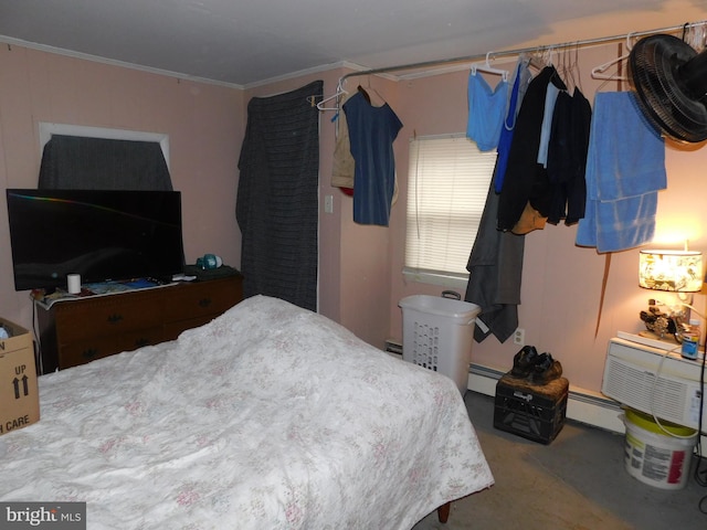 bedroom featuring a baseboard heating unit and crown molding