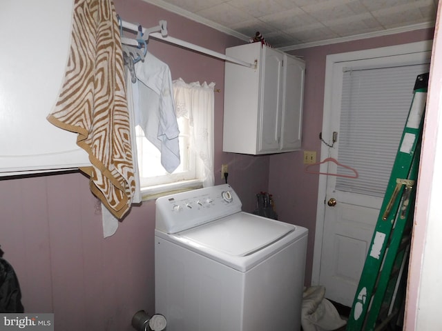 laundry area with ornamental molding, washer / clothes dryer, and cabinet space