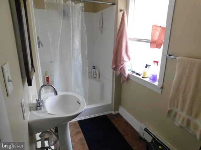 bathroom featuring a baseboard radiator, baseboards, and a shower with curtain