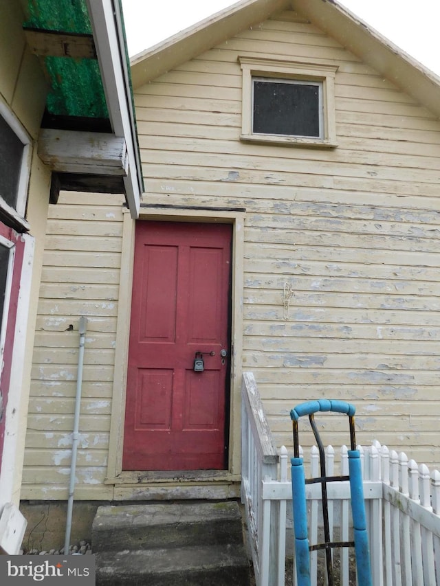 doorway to property with fence