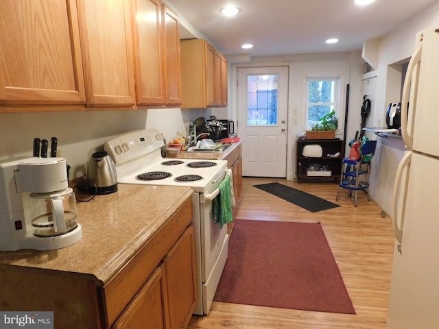 kitchen with white appliances, light countertops, light wood-style floors, and recessed lighting