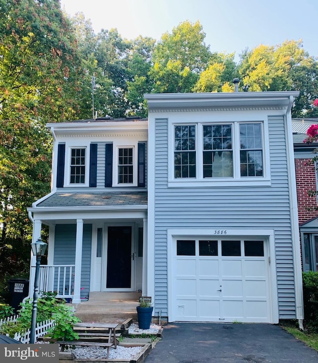 view of front facade featuring a garage and covered porch