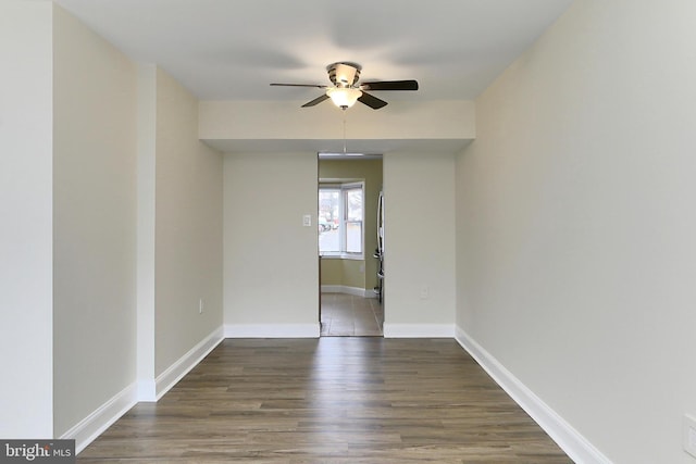 empty room featuring ceiling fan and dark hardwood / wood-style flooring