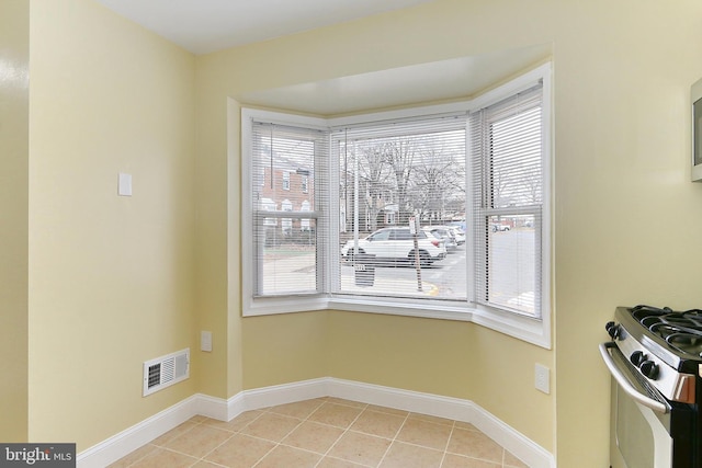 unfurnished dining area featuring light tile patterned flooring