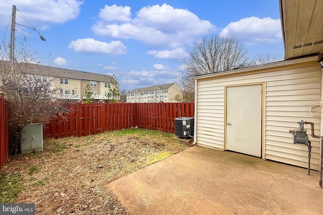 view of yard featuring an outdoor structure, a patio, and central air condition unit