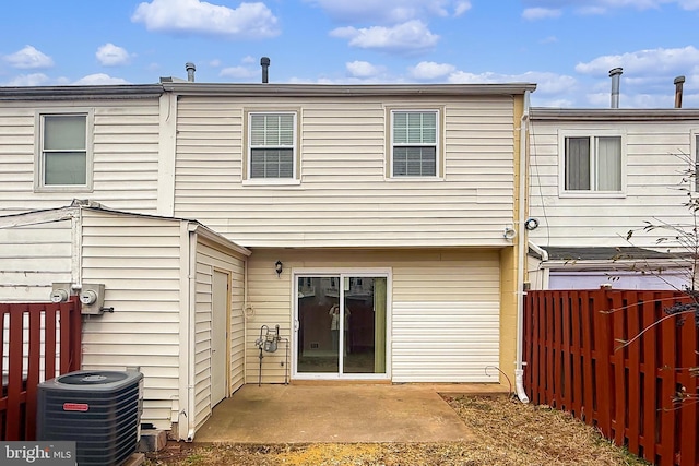 rear view of house with cooling unit and a patio