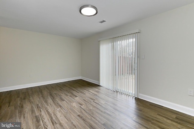 empty room with hardwood / wood-style floors