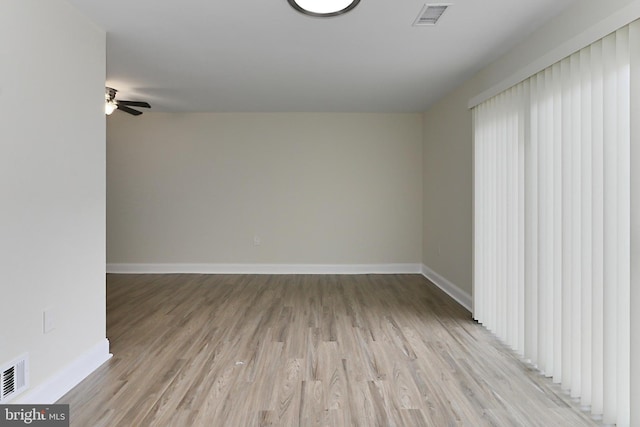 spare room featuring ceiling fan and light hardwood / wood-style floors