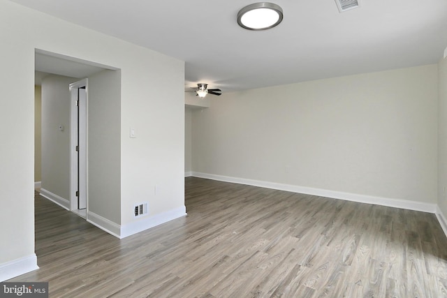 empty room with hardwood / wood-style floors and ceiling fan