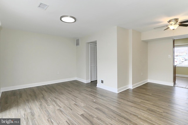 spare room featuring wood-type flooring and ceiling fan