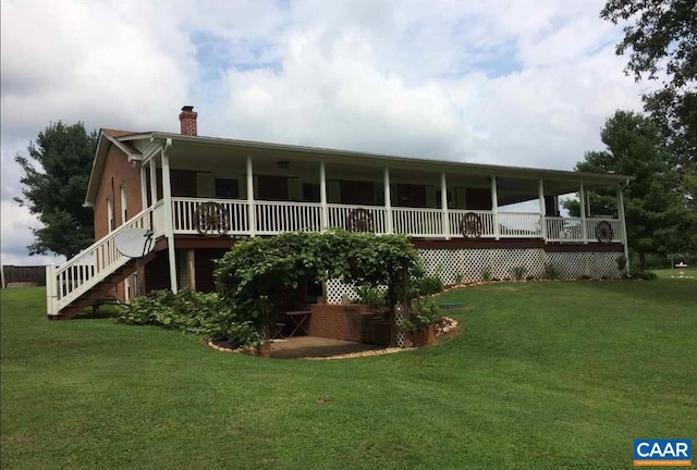 rear view of house with a yard