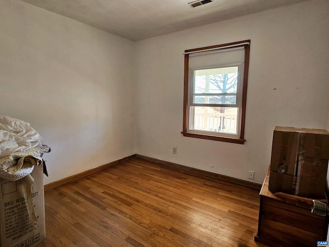 spare room featuring hardwood / wood-style flooring