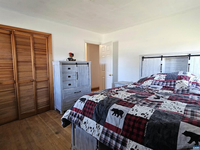 bedroom with hardwood / wood-style floors and a closet