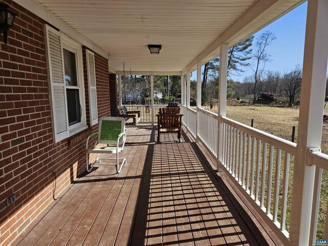 wooden terrace featuring covered porch