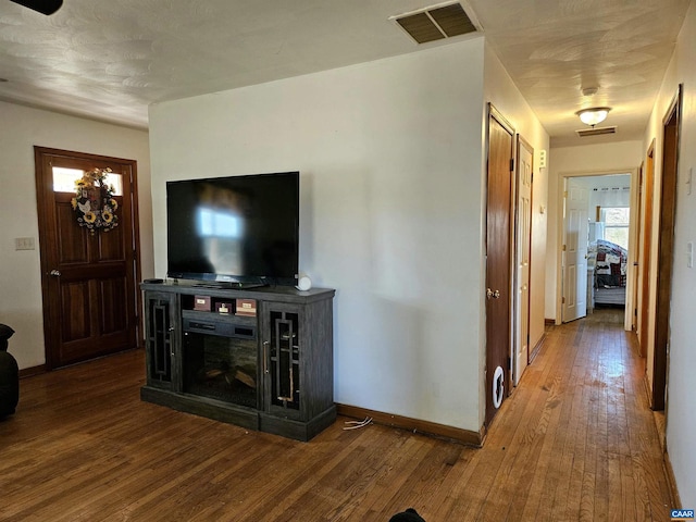 unfurnished living room featuring hardwood / wood-style flooring