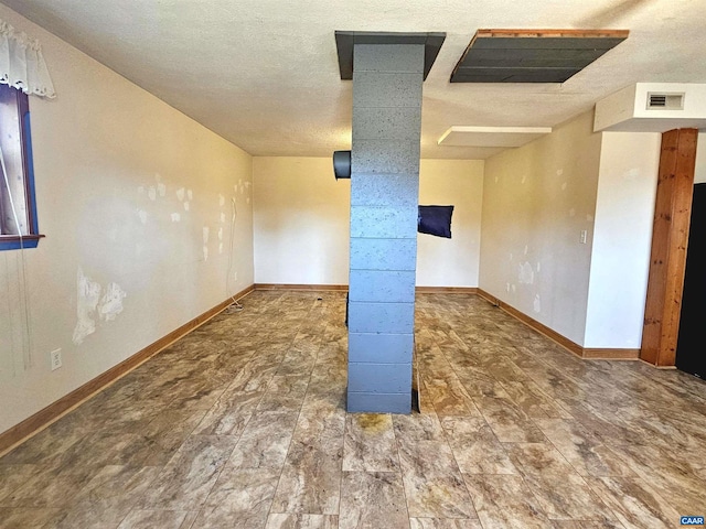 spare room featuring a textured ceiling