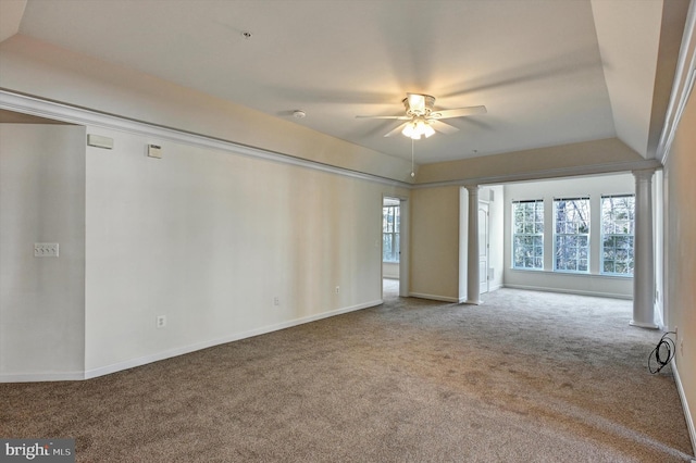 carpeted spare room with ornate columns and ceiling fan