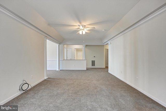 empty room with ornate columns, carpet, and ceiling fan