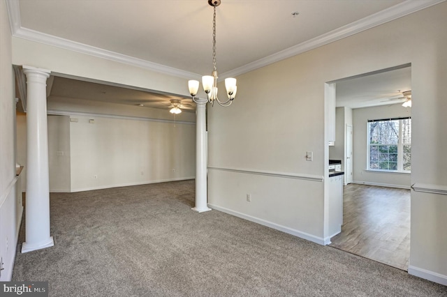 unfurnished dining area with crown molding, decorative columns, ceiling fan with notable chandelier, and carpet