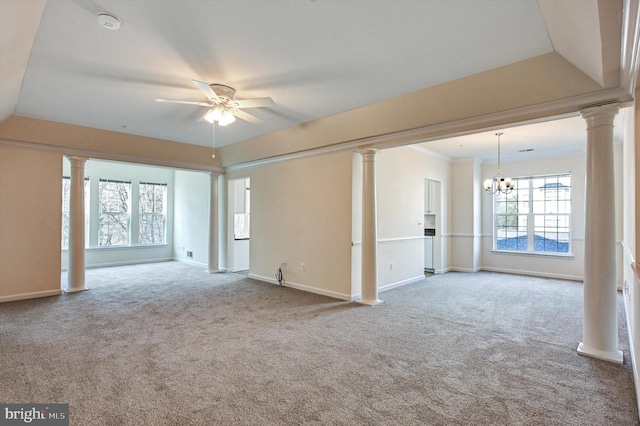 unfurnished room featuring light colored carpet, ornamental molding, ceiling fan with notable chandelier, and ornate columns