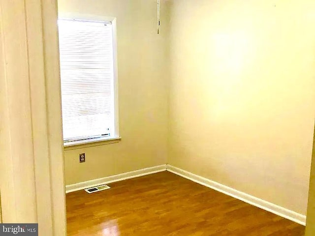 empty room with hardwood / wood-style floors