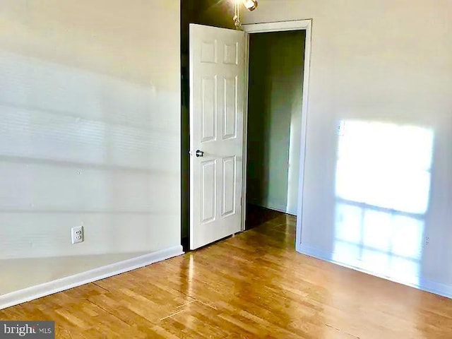 unfurnished room with hardwood / wood-style floors