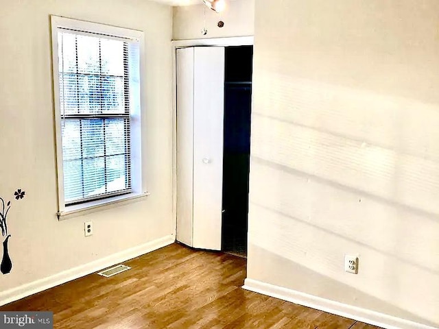 unfurnished bedroom with hardwood / wood-style floors and a closet