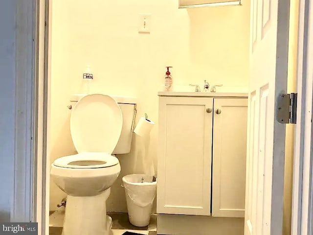 bathroom with a bidet, vanity, and toilet