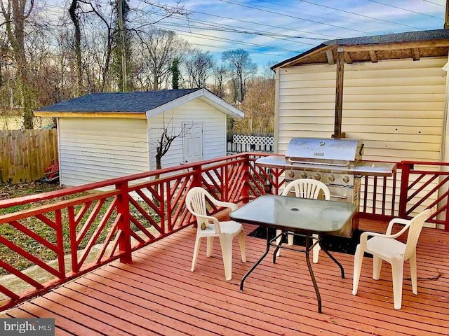 wooden terrace featuring an outdoor structure and area for grilling