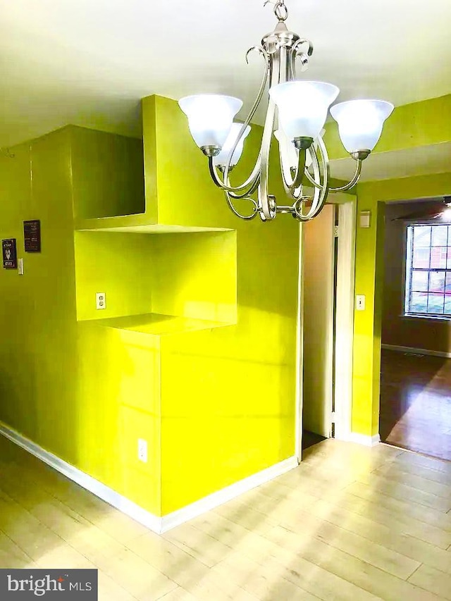 interior space featuring wood-type flooring and a chandelier