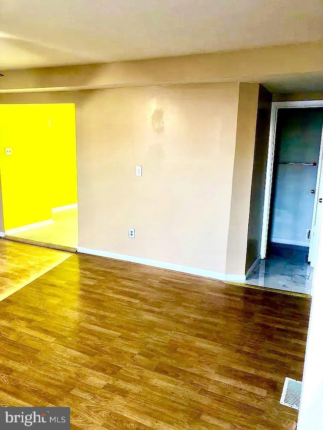 spare room featuring hardwood / wood-style floors