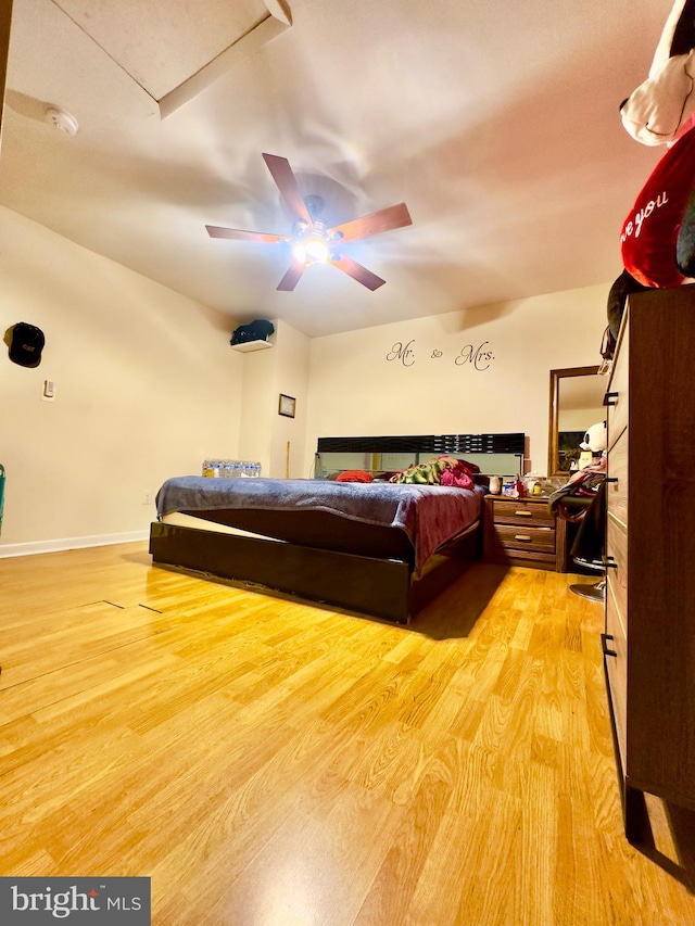 bedroom with light hardwood / wood-style flooring and ceiling fan